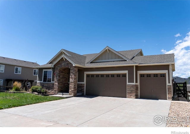 craftsman-style home featuring a garage and a front lawn