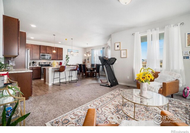 living room featuring a notable chandelier and light hardwood / wood-style floors