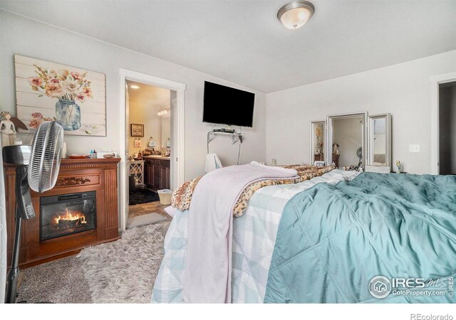 carpeted bedroom featuring connected bathroom