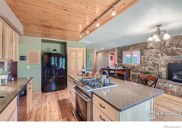 kitchen featuring light brown cabinetry, light wood-type flooring, black appliances, and track lighting