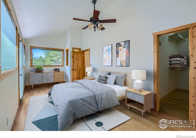 bedroom with lofted ceiling, ceiling fan, and light hardwood / wood-style flooring