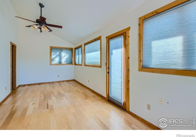 interior space with ceiling fan, lofted ceiling, and light wood-type flooring