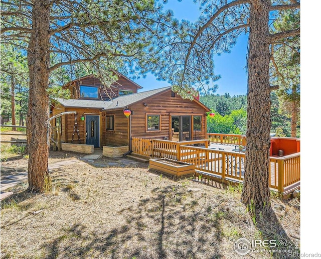 back of property featuring a wooden deck