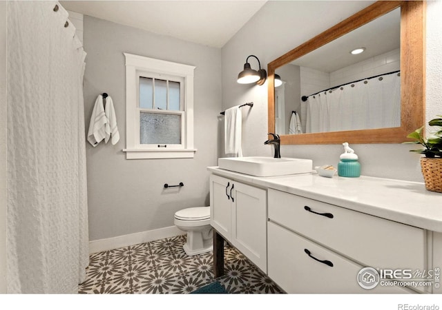 bathroom with vanity, toilet, and tile patterned flooring