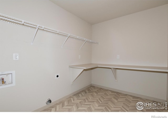 laundry area featuring washer hookup, electric dryer hookup, and light parquet floors