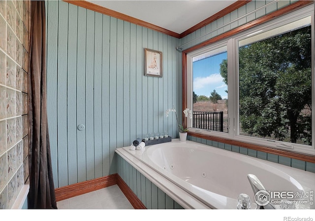 full bath featuring ornamental molding, a tub with jets, and tile patterned floors