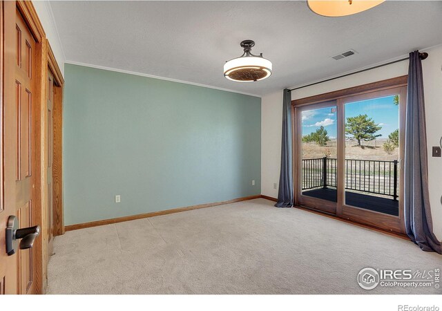 unfurnished room featuring ornamental molding and light colored carpet