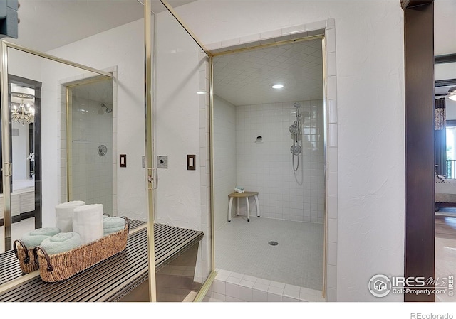 bathroom featuring a shower with door and tile patterned floors