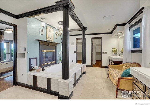 interior space with ceiling fan, light wood-type flooring, crown molding, and sink