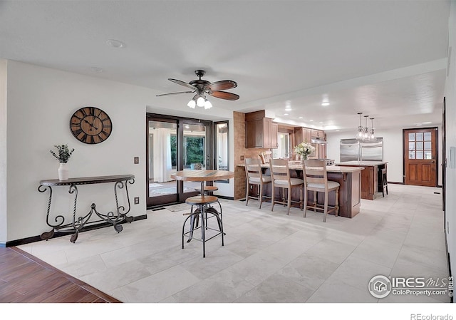 dining area featuring recessed lighting, ceiling fan, and baseboards