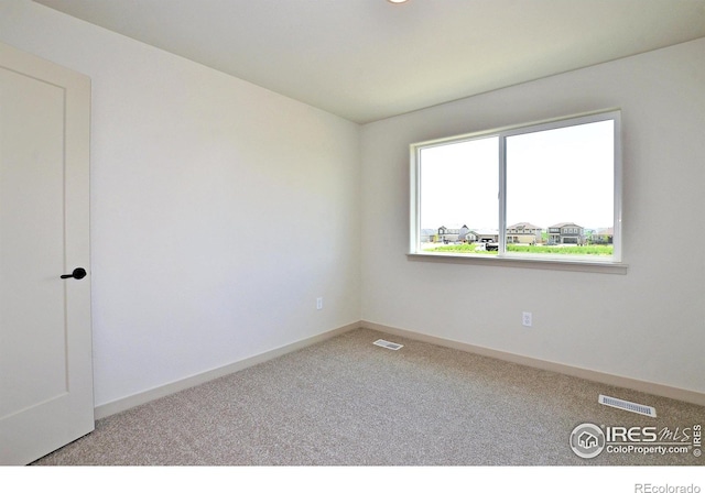 spare room with light colored carpet