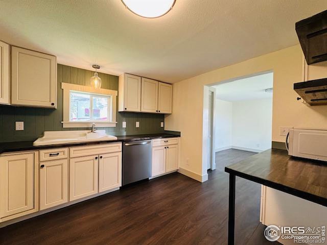 kitchen with hanging light fixtures, tasteful backsplash, white cabinetry, dishwasher, and dark hardwood / wood-style floors