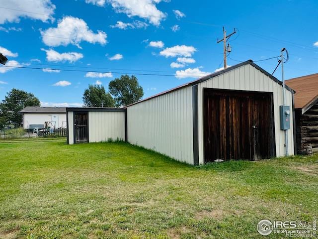 view of outbuilding featuring a yard