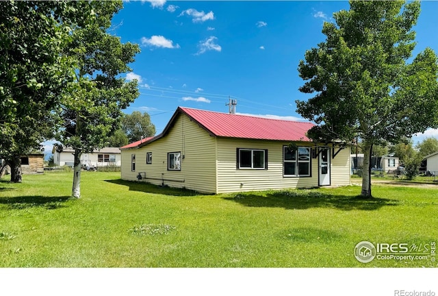 view of side of home featuring a yard