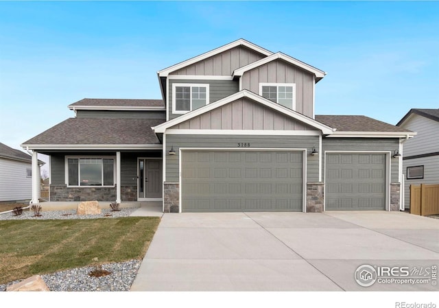 3288 Buffalo Grass Ln, Wellington, CO 80549 - craftsman house with stone siding, driveway, an attached garage, and roof with shingles