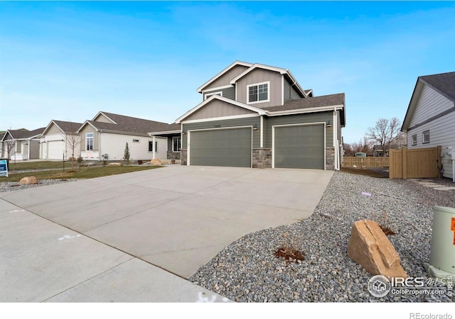 3288 Buffalo Grass Ln, Wellington, CO 80549 - craftsman house featuring board and batten siding, stone siding, concrete driveway, and a garage