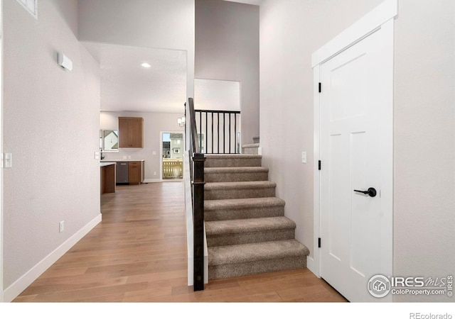 stairs featuring hardwood / wood-style flooring