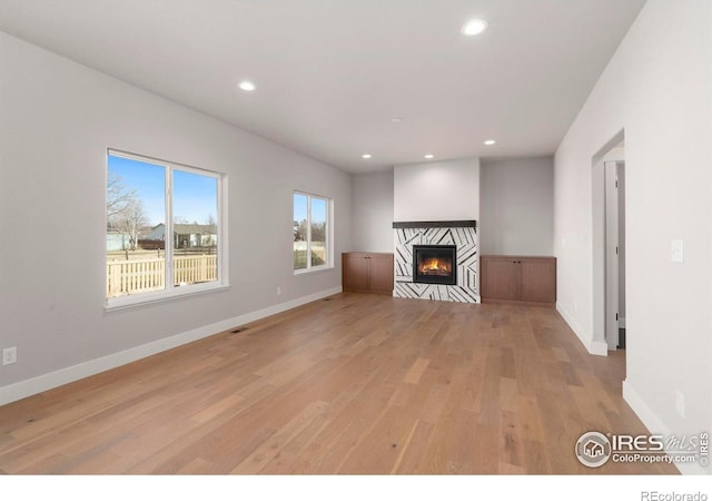 unfurnished living room with light wood-type flooring