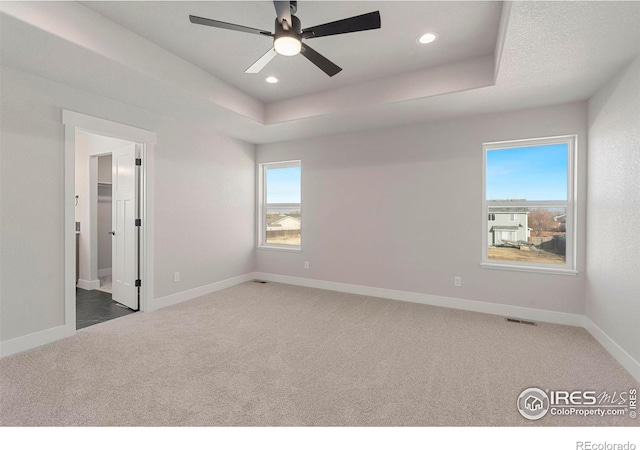 3288 Buffalo Grass Ln, Wellington, CO 80549 - unfurnished bedroom featuring carpet, baseboards, recessed lighting, a tray ceiling, and a ceiling fan