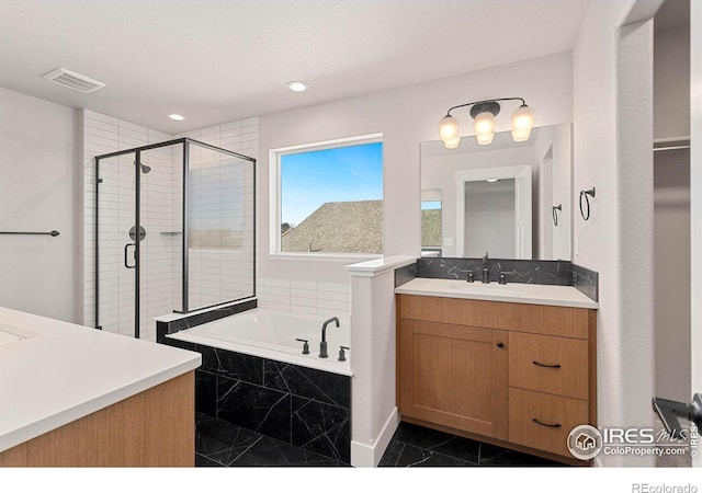 bathroom featuring vanity and independent shower and bath