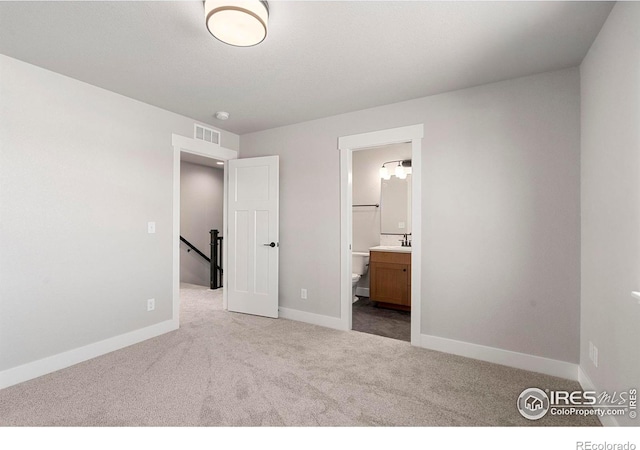 3288 Buffalo Grass Ln, Wellington, CO 80549 - unfurnished bedroom featuring a sink, carpet flooring, baseboards, and ensuite bath