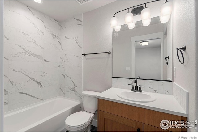 full bathroom featuring vanity, toilet, and tiled shower / bath combo