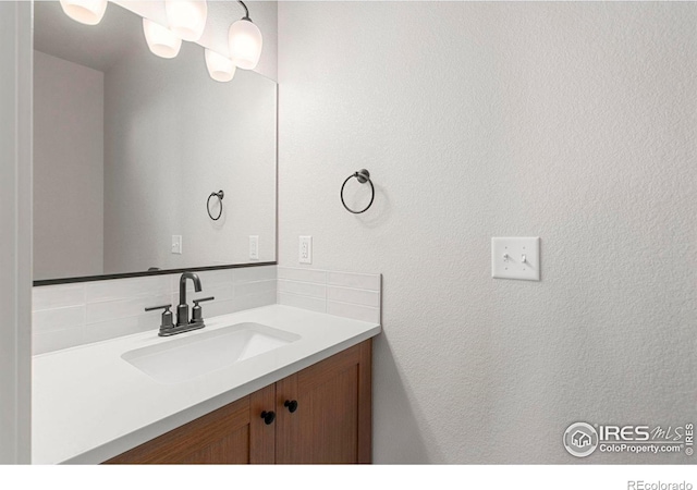 bathroom featuring decorative backsplash and vanity