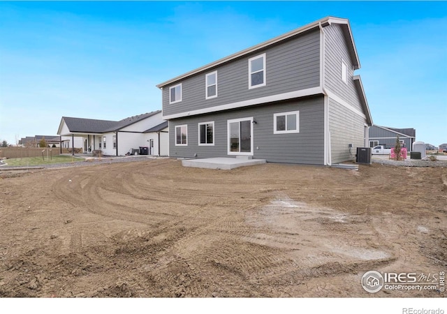 rear view of house featuring a patio and cooling unit