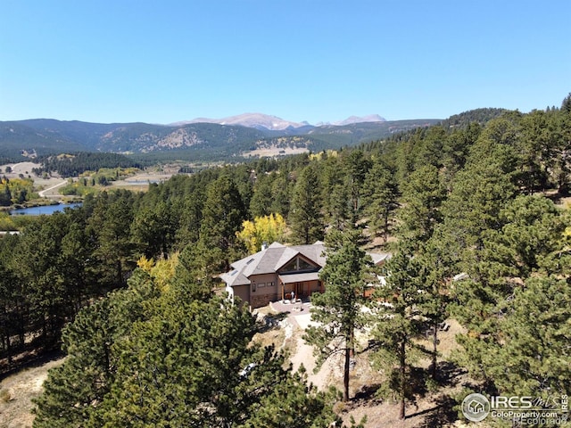 drone / aerial view featuring a mountain view and a wooded view