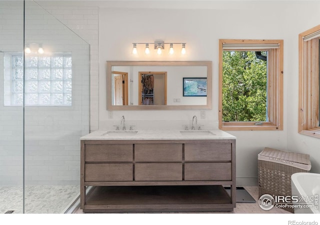 bathroom with shower with separate bathtub and dual vanity