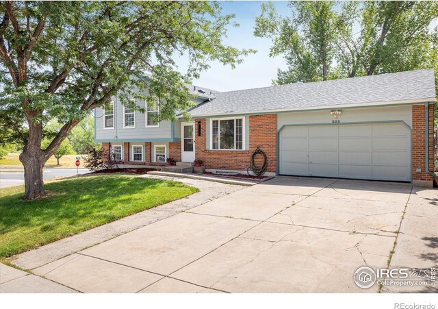 split level home featuring a garage and a front yard