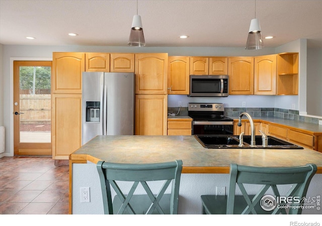 kitchen with stainless steel appliances, hanging light fixtures, a sink, and open shelves