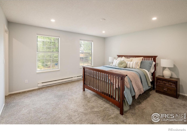 carpeted bedroom with a baseboard heating unit, a textured ceiling, and recessed lighting