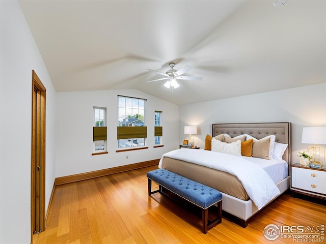 bedroom with hardwood / wood-style floors, ceiling fan, and lofted ceiling