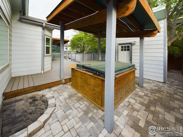 view of patio / terrace featuring a wooden deck and a hot tub