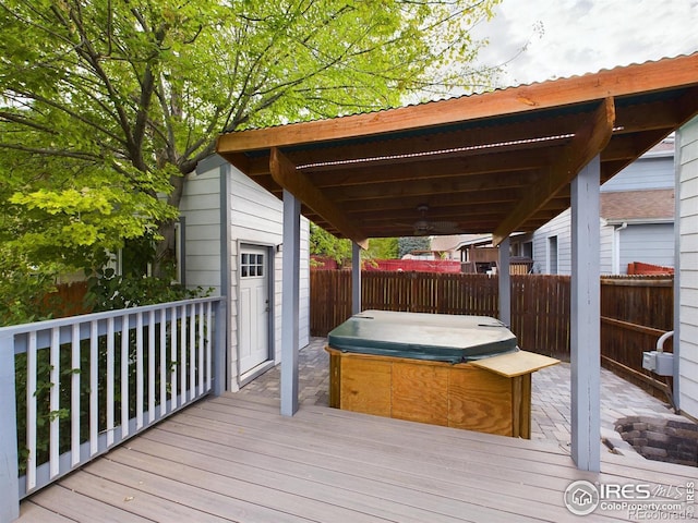 wooden terrace featuring a hot tub and ceiling fan