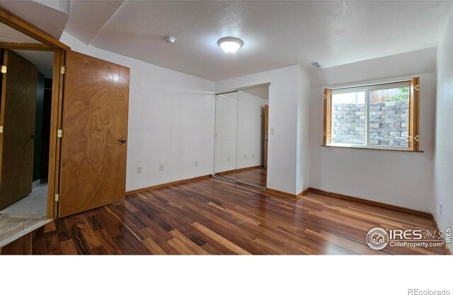 2720 E 121st Pl, Thornton, CO 80241 - unfurnished bedroom featuring wood finished floors, a closet, baseboards, and visible vents