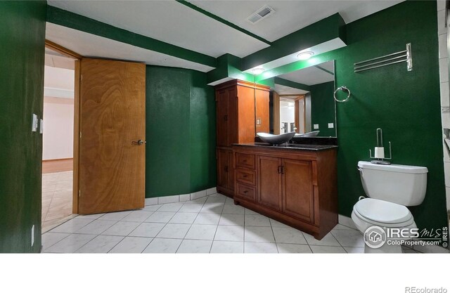 2720 E 121st Pl, Thornton, CO 80241 - bathroom with toilet, vanity, visible vents, and baseboards