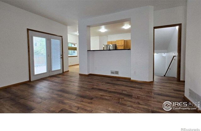 2720 E 121st Pl, Thornton, CO 80241 - unfurnished living room featuring dark wood-type flooring, visible vents, and baseboards