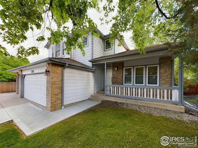 2720 E 121st Pl, Thornton, CO 80241 - split level home featuring brick siding, a porch, fence, and a garage
