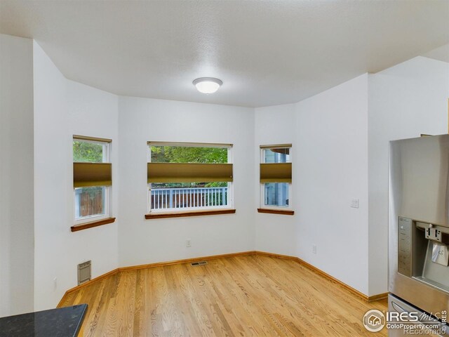 2720 E 121st Pl, Thornton, CO 80241 - spare room featuring baseboards, wood finished floors, and visible vents