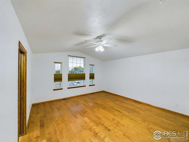 2720 E 121st Pl, Thornton, CO 80241 - additional living space with baseboards, lofted ceiling, a ceiling fan, and light wood-style flooring