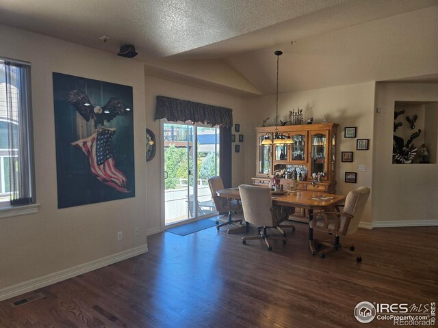 dining space with lofted ceiling, baseboards, visible vents, and wood finished floors