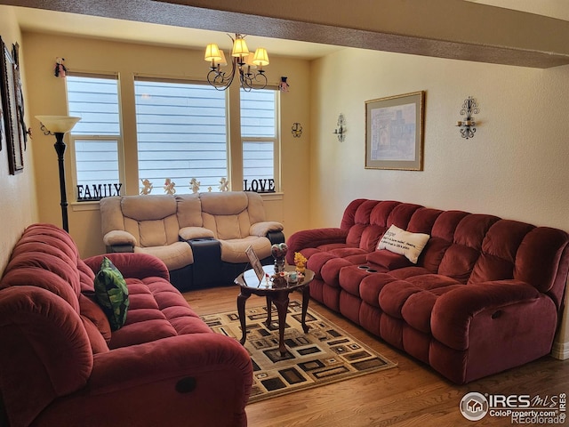 living area featuring an inviting chandelier and wood finished floors