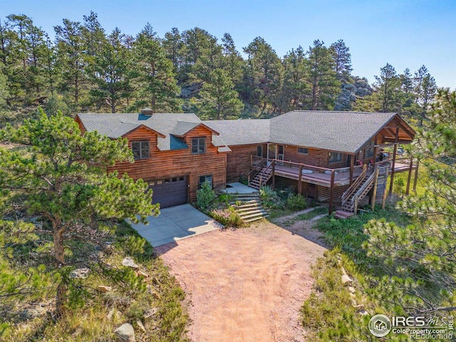 log-style house with a deck and a garage