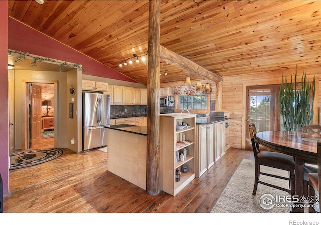 kitchen with hanging light fixtures, appliances with stainless steel finishes, light hardwood / wood-style flooring, wood ceiling, and kitchen peninsula