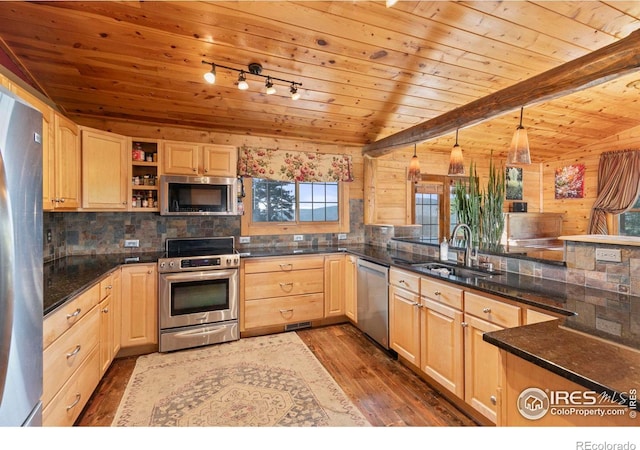 kitchen with light brown cabinets, dark hardwood / wood-style flooring, appliances with stainless steel finishes, sink, and kitchen peninsula