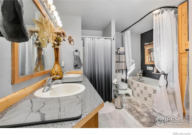 bathroom with toilet, double vanity, and tile patterned floors