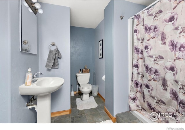 bathroom featuring toilet and tile patterned flooring