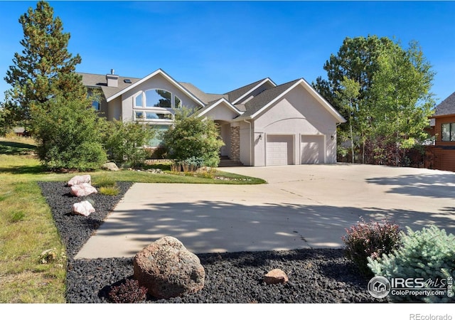 view of front of property featuring a garage and a front yard